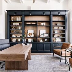 a living room filled with furniture and lots of shelves