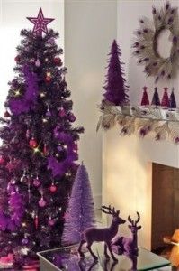 a living room decorated for christmas with purple trees and deer figurines on the coffee table