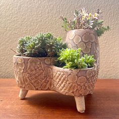 a planter with succulents in it sitting on a table