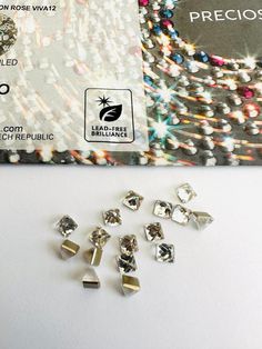 several pieces of diamond sitting next to each other on a white surface with an advertise