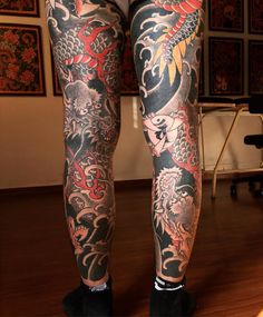 a man with tattoos on his legs and leggings