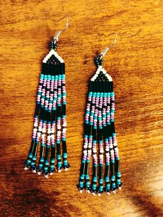 3in black, purple and turquoise beaded fringe earrings Purple Beaded Fringe Drop Earrings, Purple Fringe Beaded Earrings As Gift, Purple Fringe Beaded Earrings For Gift, Purple Earrings With Beaded Fringe, Purple Jewelry With Beaded Fringe And Round Beads, Purple Beaded Fringe Dangle Tassel Earrings, Purple Beaded Fringe Tassel Earrings, Purple Bohemian Jewelry With Black Beads, Bohemian Purple Jewelry With Black Beads