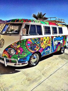 an old vw bus painted with colorful designs