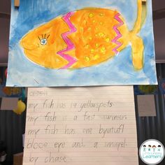 a child's drawing of a fish on a piece of paper with writing underneath it