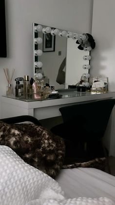 a bedroom with a large mirror and vanity