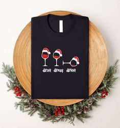 Drink Drank Drunk Christmas Shirt, Funny Christmas Tee, Wine Lover Gift, Wine Glass Shirt, Christmas Wine T-Shirt, Holiday Drinking Shirt WELCOME TO "Graphic Shirt" ! High quality and super soft, comfortable shirt. Made with top of the line vinyl and pressed with a professional grade heat press. All our simple color ones like White, Black, and Red are 100% Cotton. All our Heathered Colors are cotton/polyester blend and they are super comfy soft! SIZING AND COLORS Make sure you check our size-cha Christmas Wine Glass Tshirt, Christmas Drinking Shirts, Drinking Shirts Women, Drink Drank Drunk, Christmas Drinking, Christmas Shirt Funny, Wine Shirt, Cute Christmas Shirts, Gift Wine