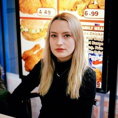 a woman sitting at a table in front of a menu