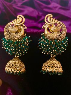 Add elegance to your Indian outfit with our Antique Peacock Earrings, available in 4 different colors. Crafted with intricate details, these earrings are a timeless addition to your jewelry collection. Elevate your style with the beauty of these stunning earrings. Length - 7 cm Jewellery Care- Keep the jewelry dry, avoid heat and contact with perfumes & water. Jhumkas Gold, Beautiful Gold Earrings, Gold Jhumka Earrings, Peacock Earrings, Bridal Choker, Fancy Blouses, Jhumka Earrings, Indian Outfit, Antique Earrings