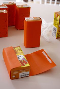 some orange boxes sitting on top of a white table