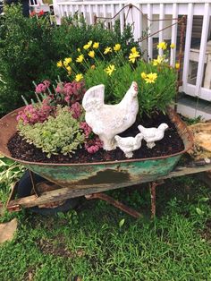 a wheelbarrow filled with flowers and chickens