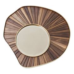 a brown and white plate sitting on top of a wooden table next to a mirror