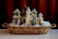 a basket filled with fake trees on top of a table