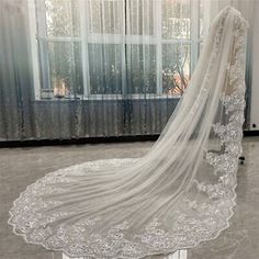 a wedding veil on display in front of a window