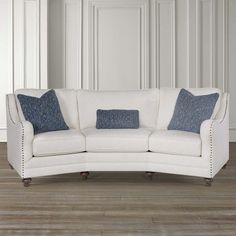 a white couch sitting on top of a hard wood floor