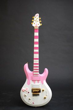 a pink and white guitar shaped like a cat