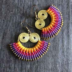 Unique fun multicolor macrame earrings. Made with brass wire, a mix of yellow, orange, violet, fuchsia and magenta brasilian wax cords, and small brass beads. All put together creating this unique fun bright pair that will rock your outfit. Perfect for your day by day outfits. The earrings are 3.2cm- 1.30 inch long 5cm- 2 inch wide Drop length of 4.6cm- 1.90 inch They are super light what makes them easy to wear. A unique addition to your jewelry collection Enjoy Con salud Multicolor Macrame Earrings As Gift, Adjustable Macrame Earrings For Jewelry Making, Adjustable Macrame Earrings, Brasilian Wax, Multicolor Macrame, Magenta Earrings, Violet Earrings, Earrings Macrame, Wiccan Necklace