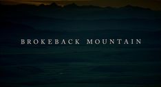 the words brokeback mountain are lit up in the dark night sky above some mountains