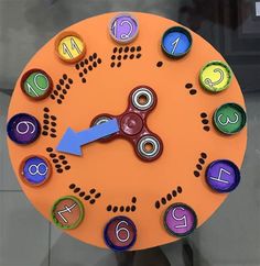 an orange clock with colorful numbers on it