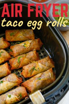 air fryer taco egg rolls in a black crock pot with text overlay