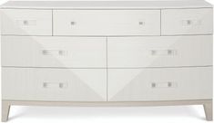 a white dresser with four drawers and two doors