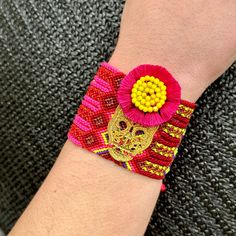 Bring the vibrant energy and handmade charm of Oaxaca, Mexico to your own wrist with our Woven Bracelet with Calaca Charm. This stunning piece combines the traditional techniques of Oaxacan weaving with the whimsy of boho-inspired fashion. Every bracelet is handwoven by skilled artisans in Oaxaca, using vibrant and durable threads that create intricate patterns and cheerful colors. The woven design adds texture and depth to the bracelet, allowing it to stand out from other accessories. The focal Mexican Calavera, Wool Knit Scarf, Handcrafted Boots, Painted Hats, Mexican Jewelry, Woven Bracelet, Shoulder Backpack, Vibrant Energy, Textile Jewelry