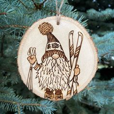 a wooden ornament hanging from a tree with skis and a hat on it