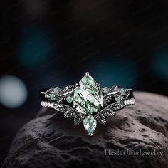 a green ring with leaves on it sitting on top of a rock in the dark