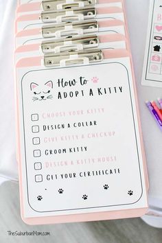 a pink and white binder with instructions for how to adopt a kitty on it