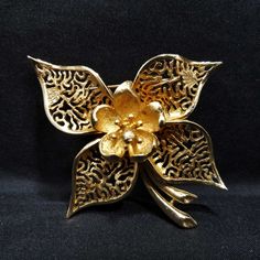 Vintage Coro Flower Brooch, Gold Plated, 1950s Jewelry *Description: This is a beautiful Coro flower brooch from the 1950s. It is 10 KG on the surface; acid tested. The flower has a brushed gold finish with open filigree petals and a solid brushed gold on the center. This would be a perfect wedding brooch. It would look beautiful on a wedding bouquet and be a keepsake for years to come. It would also make a great gift to wear on your favorite jacket, hat, or bag. *Approximate Measurements: Lengt Vintage Gold Flower Shaped Brooch, Retro Flower Brooches For Collectors, Vintage Flower Brooch Jewelry, Vintage Flower Lapel Pin Gift, Vintage Flower Lapel Pin For Gift, Mid-century Flower Jewelry Gift, Vintage Gold Flower Brooch, Vintage Gold Flower Brooches, Vintage Flower Brooch For Evening