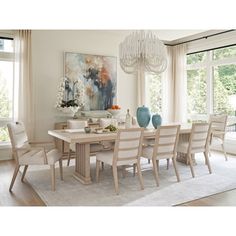 a dining room table with chairs and a chandelier