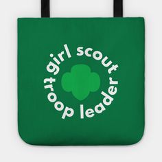 a green tote bag with the words girl scout on it and a shamrock leaf