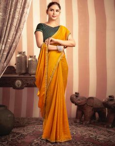 Turmeric Yellow Stone Work Embellished Silk Saree  Turmeric Yellow Stone Work Embellished Silk Saree is a luxurious and elegant piece. The rich silk fabric drapes beautifully, creating a flowing and sophisticated look. The intricate stone work, which can feature floral motifs, geometric patterns, or abstract designs, adds a touch of opulence and sparkle.  Features Of Turmeric Yellow Stone Work Embellished Silk Saree  Traditional Handloom Craft  Intricate Gold Brocade Work  Durability and Longevi Turmeric Yellow, Saree Traditional, Gold Brocade, Navratri Special, Abstract Designs, Yellow Stone, Stone Work, Draped Fabric, Floral Motifs