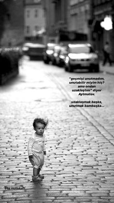 a small child standing on top of a brick road