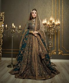 a woman in a wedding dress standing next to a chandelier with candles on it