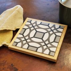 a wooden tray sitting on top of a table next to a pot