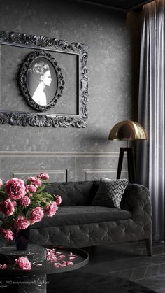 a living room filled with furniture and flowers in front of a framed photo on the wall