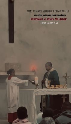 the priest is lighting candles at the alter in front of people sitting on the pews