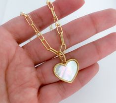 Mother of pearl heart necklace MATERIAL AND SIZE Mother of pearl heart 18k Gold filled chain Medal size: 2.5cm Necklace length: 18 inches If you have questions about the product, feel free to reach me out. Don't forget to check out my other items in the store: Https://www.etsy.com/shop/nyahwithlove Valentine's Day Heart Pendant Pearl Necklace, Heart Pendant Pearl Chain Charm Necklace As Gift, Valentine's Day Pearl Necklace With Heart Charm, Valentine's Day Heart-shaped Pearl Necklace With Charm, Valentine's Day Heart Charm Pearl Necklace, Valentine's Day Heart-shaped Pearl Charm Necklace, Mother's Day Heart-shaped Pearl Necklace, Heart Shaped Pearl Chain Necklace Gift, Heart-shaped Pearl Chain Charm Necklace For Gift