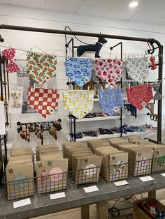 many different items are on display in a shop with tags hanging from the ceiling, and baskets lined up behind them