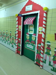 a hallway decorated with christmas themed doors and candy canes on the door for santa's helpers