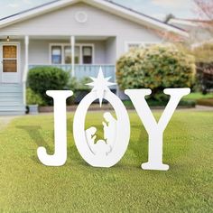 the word joy in front of a house with a nativity scene cut out of it