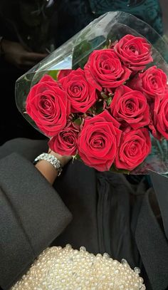 a bouquet of red roses sitting on top of a table