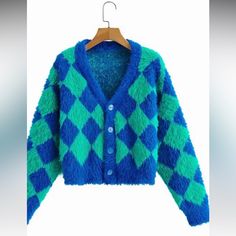 A Slightly Cropped Length Long Sleeve Faux Mohair Cardigan With Dropped Shoulders In The Softest Fuzziest (Never Scratchy Like Actual Mohair!) Bright Green And Blue Harlequin Diamond Pattern --Perfect To Pair With Your High-Waisted Faves For A Cozy Pop Of Color! 85% Acrylic 15% Polyester Trendy Light Blue Winter Cardigan, Blue Long Sleeve Acrylic Outerwear, Blue Acrylic Outerwear For Fall, Trendy Blue Acrylic Outerwear, Fitted Cozy Blue Outerwear, Blue Fitted Warm Outerwear, Fitted Blue Cozy Outerwear, Cozy Blue Fitted Outerwear, Blue Trendy Acrylic Cardigan