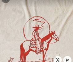 a drawing of a cowboy riding a horse on a white sheet with red ink in it