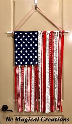 an american flag hanging on a door with the words be magic creations written below it