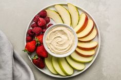 apples, strawberries and apple slices on a plate with dip