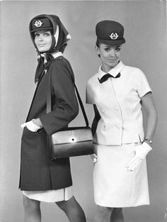 two women dressed in uniforms and hats posing for the camera with one holding a purse