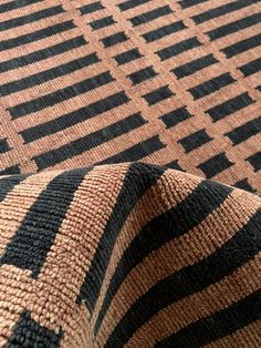 a close up view of a black and brown striped fabric