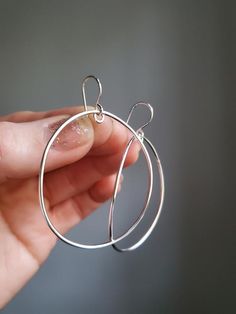 These big bold drop hoops are handmade by me using a nice thick gauge wire, so they feel substantial, yet are lightweight and comfortable to wear. I've given these a nice arch for a hint of depth. The little notch at the top ensures these always hang just so, rather than having the oval accidentally rest on its side at times. Lots of movement  with these clean, minimalist statement earrings. Entirely soldered together by my own two hands. Total length: 2 1/4in  (6cm)total width: 1 1/2in (4cm)100 Modern Wire Wrapped Hoop Earrings, Modern Handmade Metal Hoop Earrings, Everyday Handmade Metal Hoop Earrings, Everyday Small Hoop Earrings Wire Wrapped, Minimalist Wire Wrapped Hoop Earrings, Minimalist Wire Wrapped Round Hoop Earrings, Minimalist Wire Wrapped Round Earrings, Handmade Modern Open Circle Earrings, Handmade Everyday Circular Earrings