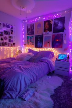 a bedroom with purple lights and pictures on the wall